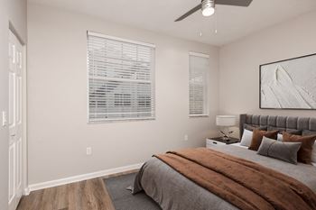 A bedroom with a bed, pillows, and a ceiling fan at Floresta, Jupiter, 33458